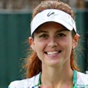 Professional headshot of Coach Emily White, a female tennis coach with an energetic expression.