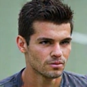 Professional headshot of Coach Alex Rodriguez, a male tennis coach with a thoughtful look.