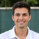 Professional headshot of Coach David Chen, a male tennis coach with a friendly smile.