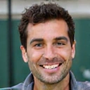 Professional headshot of Coach Marcus Johnson, a male tennis coach with a warm smile.